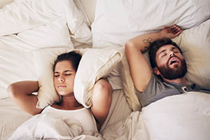 Groaning - woman can't sleep next to sleeping husband